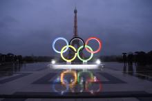 Photograph of the Olympic rings in front of the Eiffel Tower.