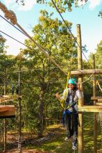 Photo of someone on a ropes course