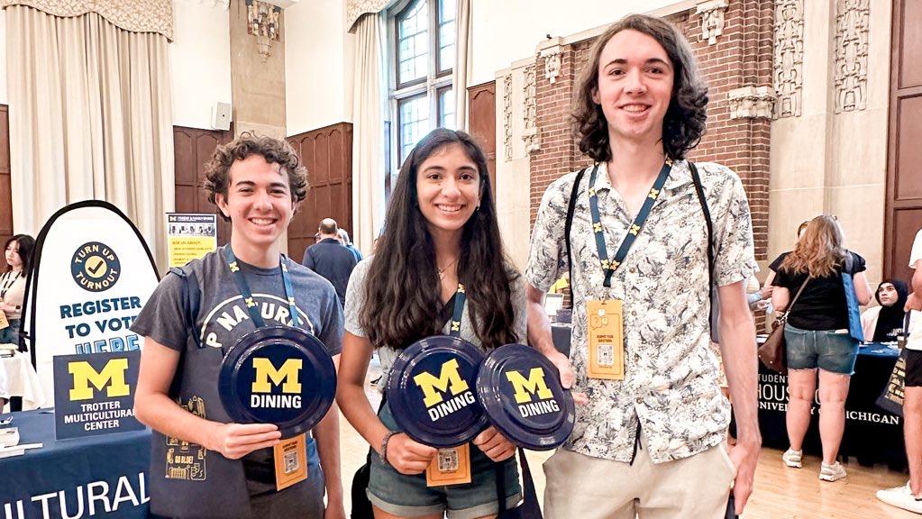 Photograph of 3 students holding MDining plates.