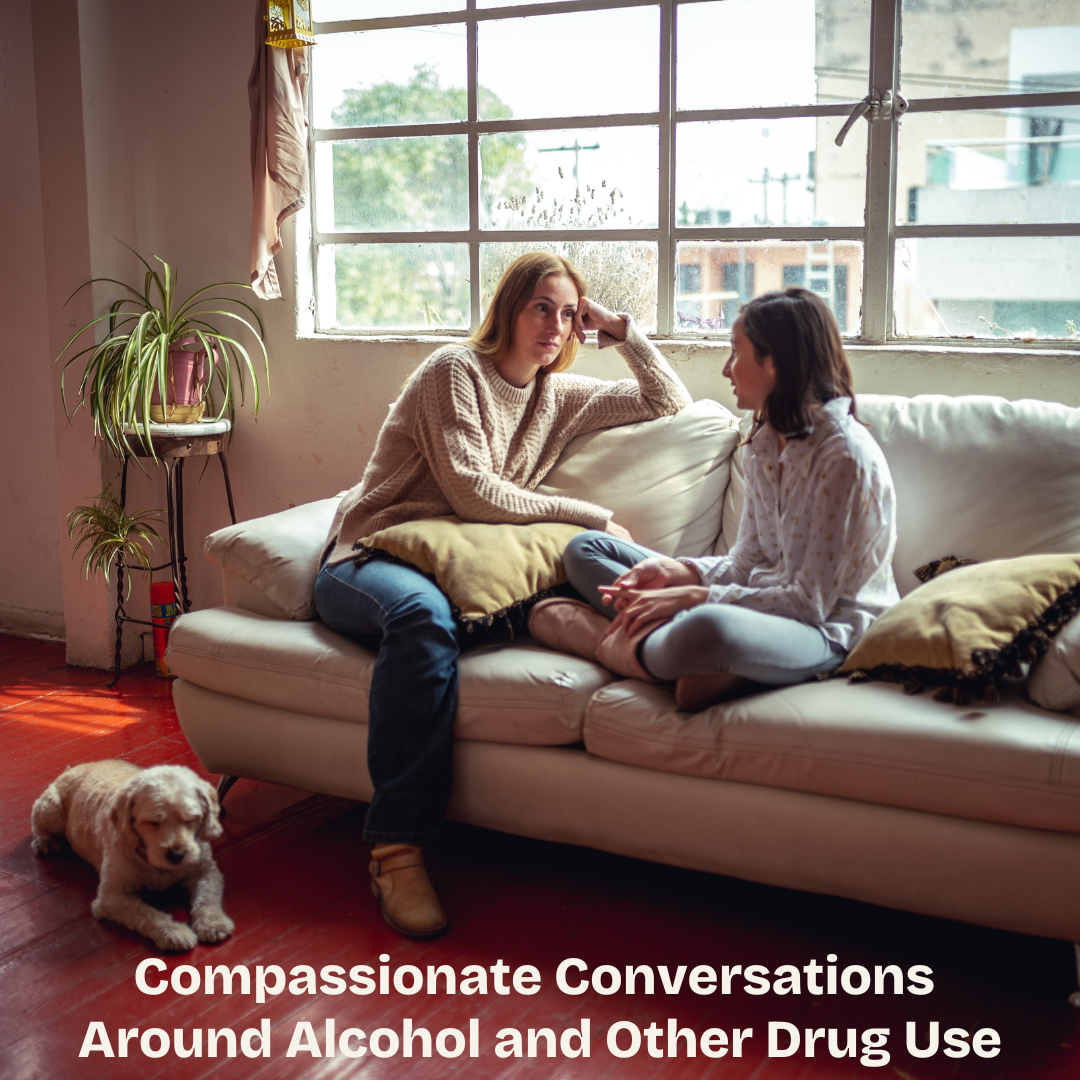 Photograph of family members sitting on a couch and talking.