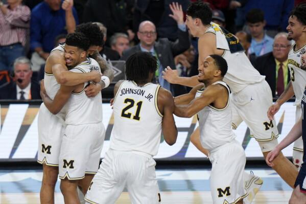 Men's basketball team celebrating after winning the final game